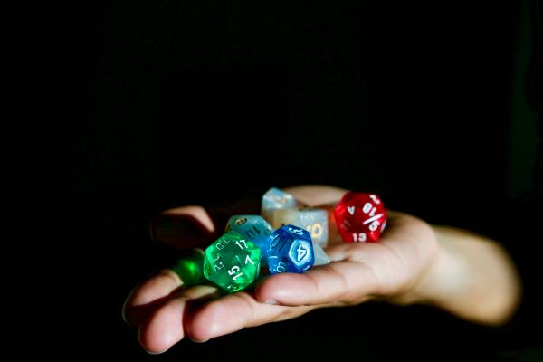 Hand holding various RPG dice