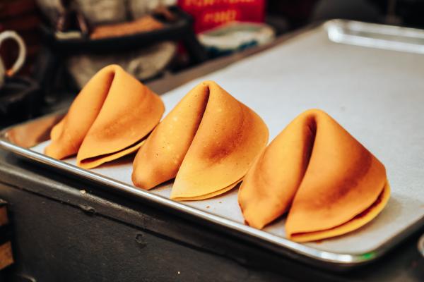 Image of three fortune cookies on baking sheet.