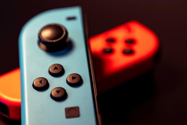 blue Nintendo Switch controller in foreground, red in back