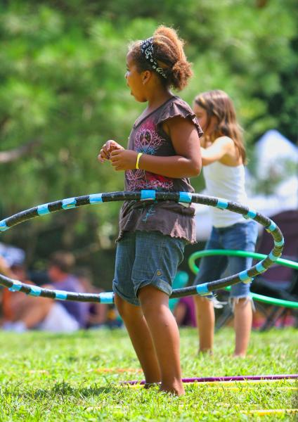 Girl using a blue and black hula-hoop