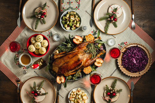 Overhead image of a holiday table with various colors and varieties of festive food options