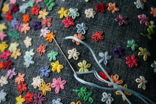 needle and hand stitched flowers