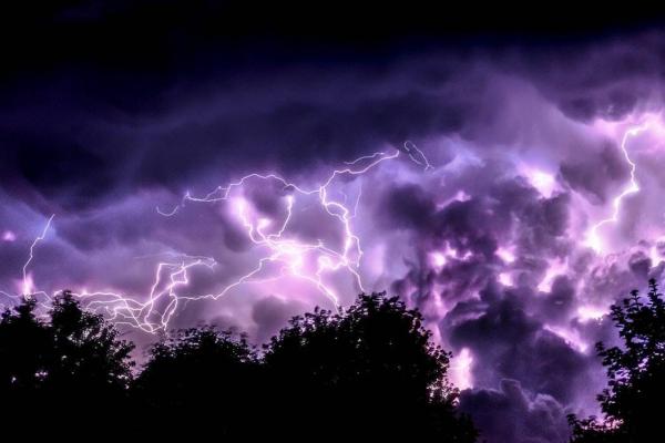 Photo of lightning with a purple sky