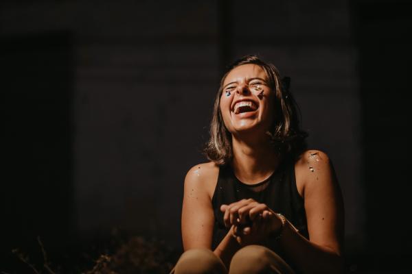 A woman in a black top laughing