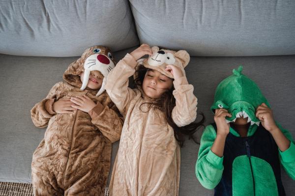 Three children dressed up as walrus, bear, and dinosaur