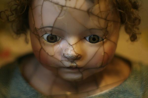 closeup of cracked porcelain girl doll