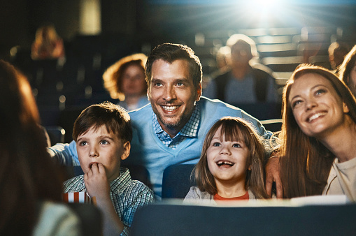 image of a family of four viewing a film
