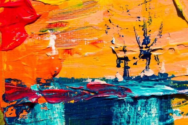 abstract painting in yellow, red, orange, blue, and black