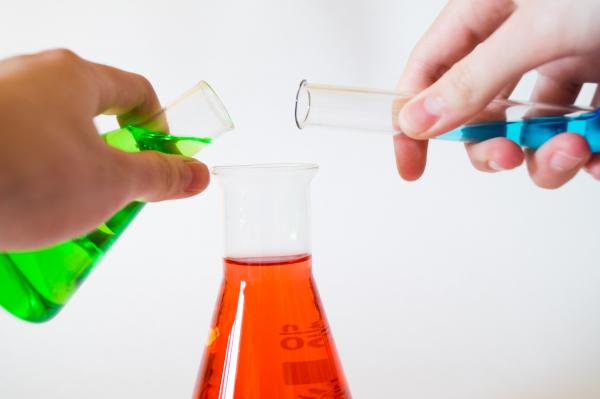 colored liquid pouring into a beaker