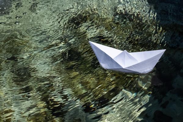 a paper boat floating in the water