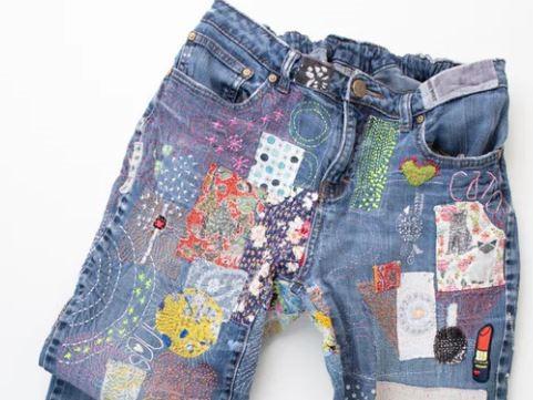 A pair of jeans with many colorful patches.