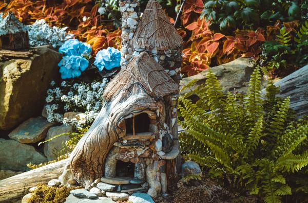 Image of fairy house sitting in a garden.