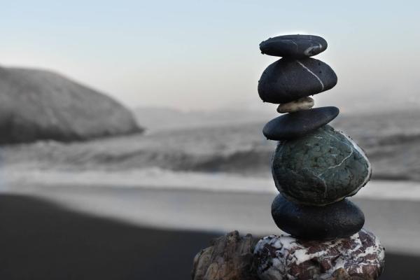 cairn of rocks on a beach with the 