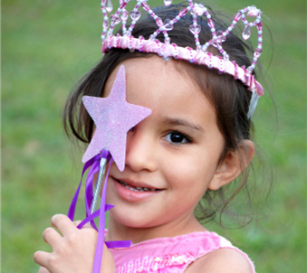 Image of child holding up a paper wand with a star.