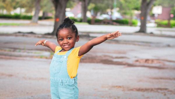 image of young Black girl stretching her arms